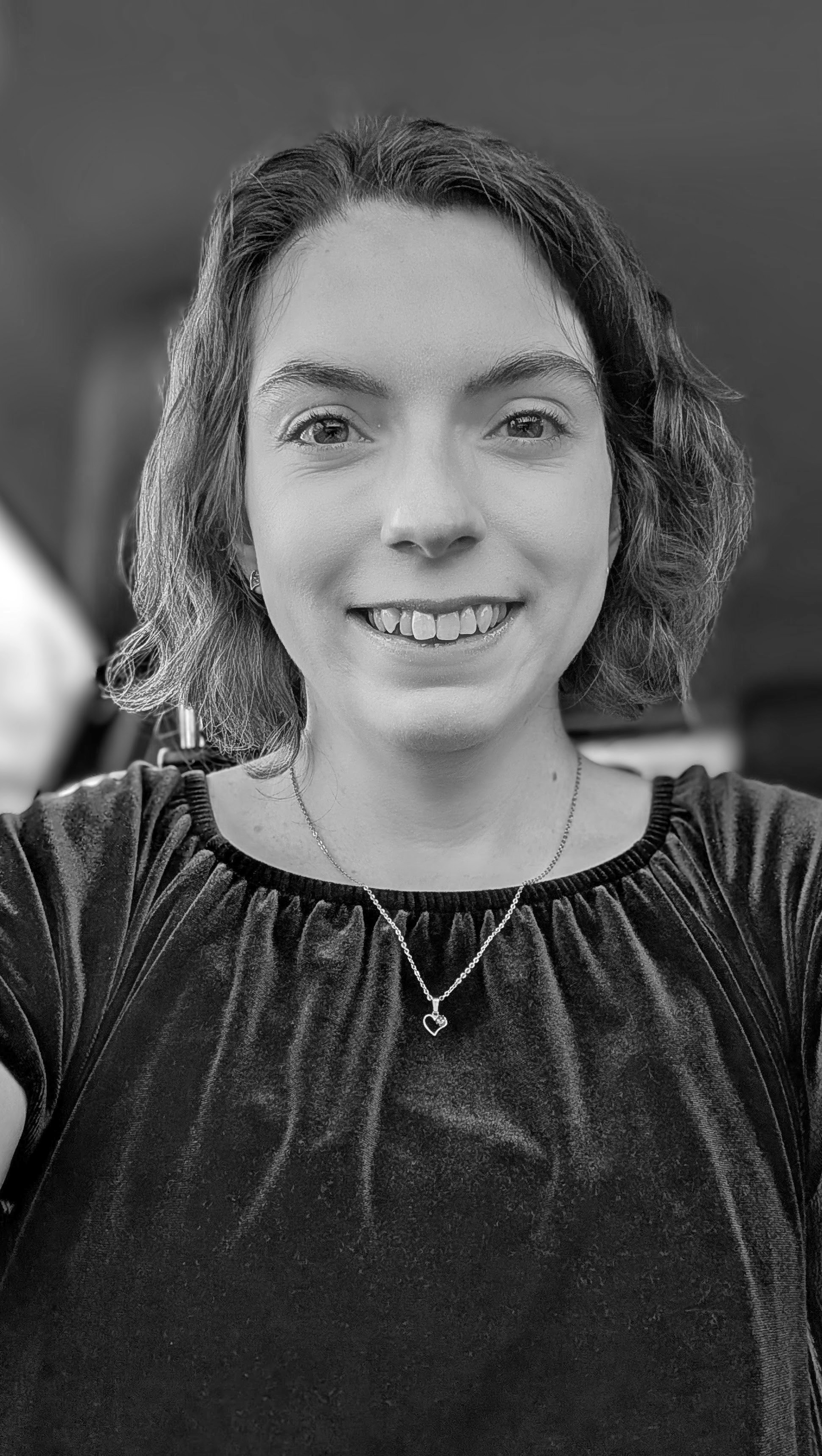 Brunette female with chin length bob wearing a dark velvet shirt